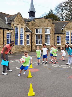 students run soccerdrills with teachers during gym class