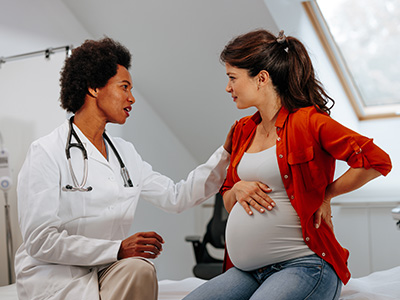 a doctor talks to a pregnant patient